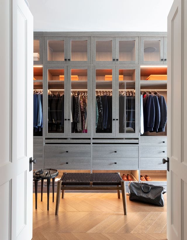 Ryan Serhant's custom designed closet with storage drawers, cabinets and glass doors by California Closets