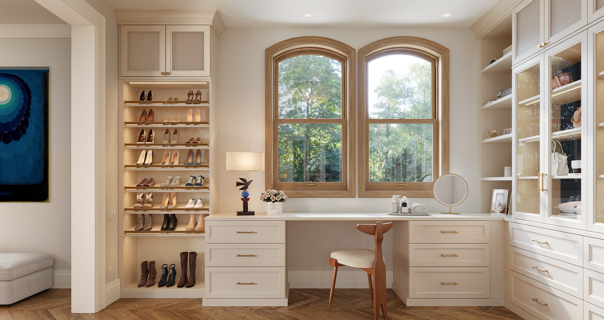 Cloffice designed with custom cabinets, open shelves for shoe storage and a desk in light wood finish by California Closets