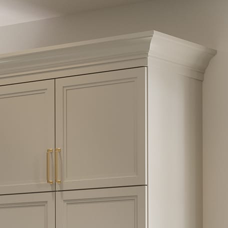 Custom wardrobe closet design with molding and trim created by California Closets