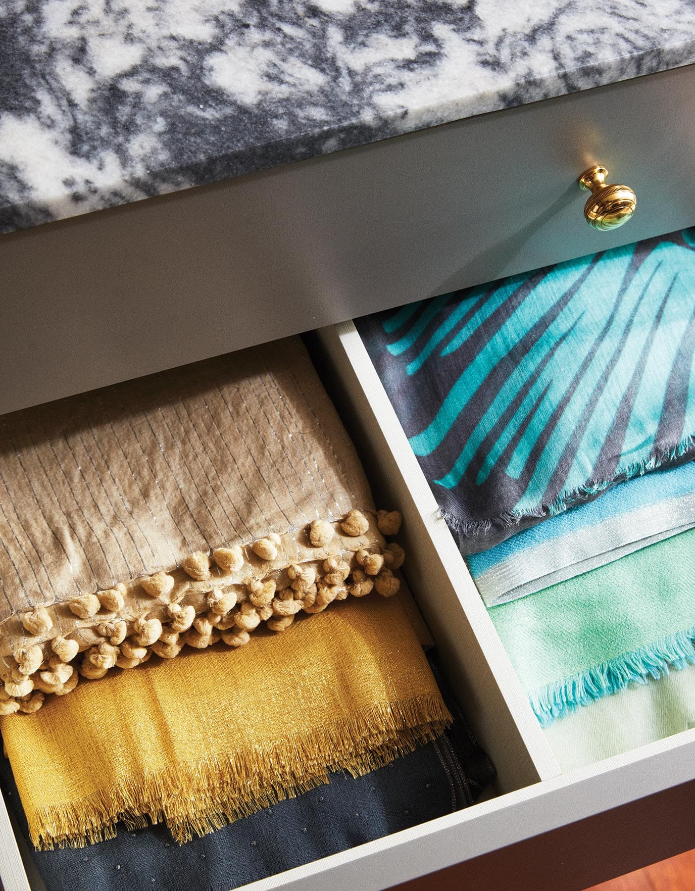 Each of Martha's drawers is dedicated to one item; in this drawer, scarves are staggered so each one is visible in Ideas of Order Magazine