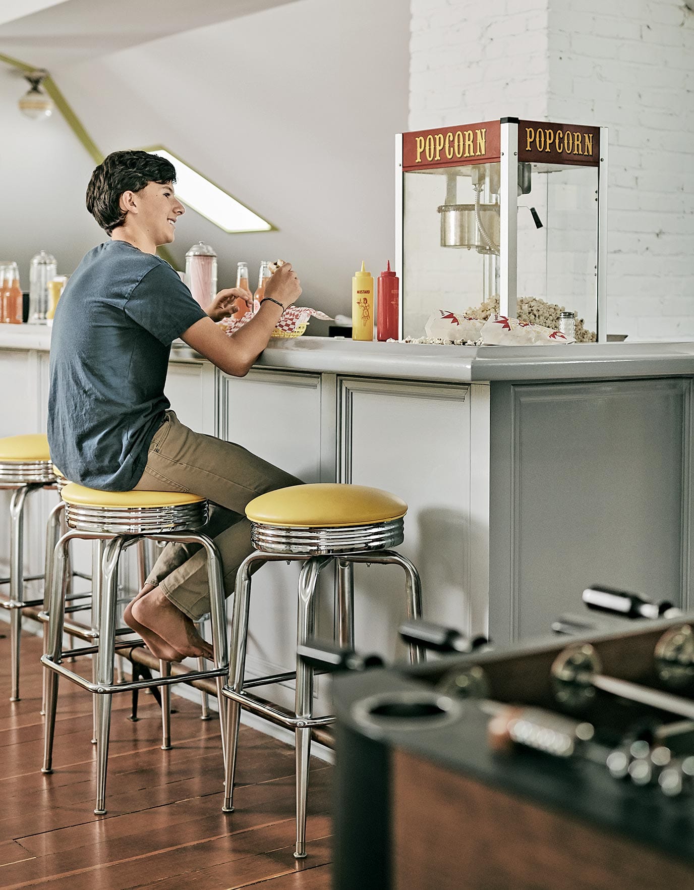 Cool hangout space for Lily Kanter's family home with bar stooks, counter and diner feel as told to Ideas of Order Magazine