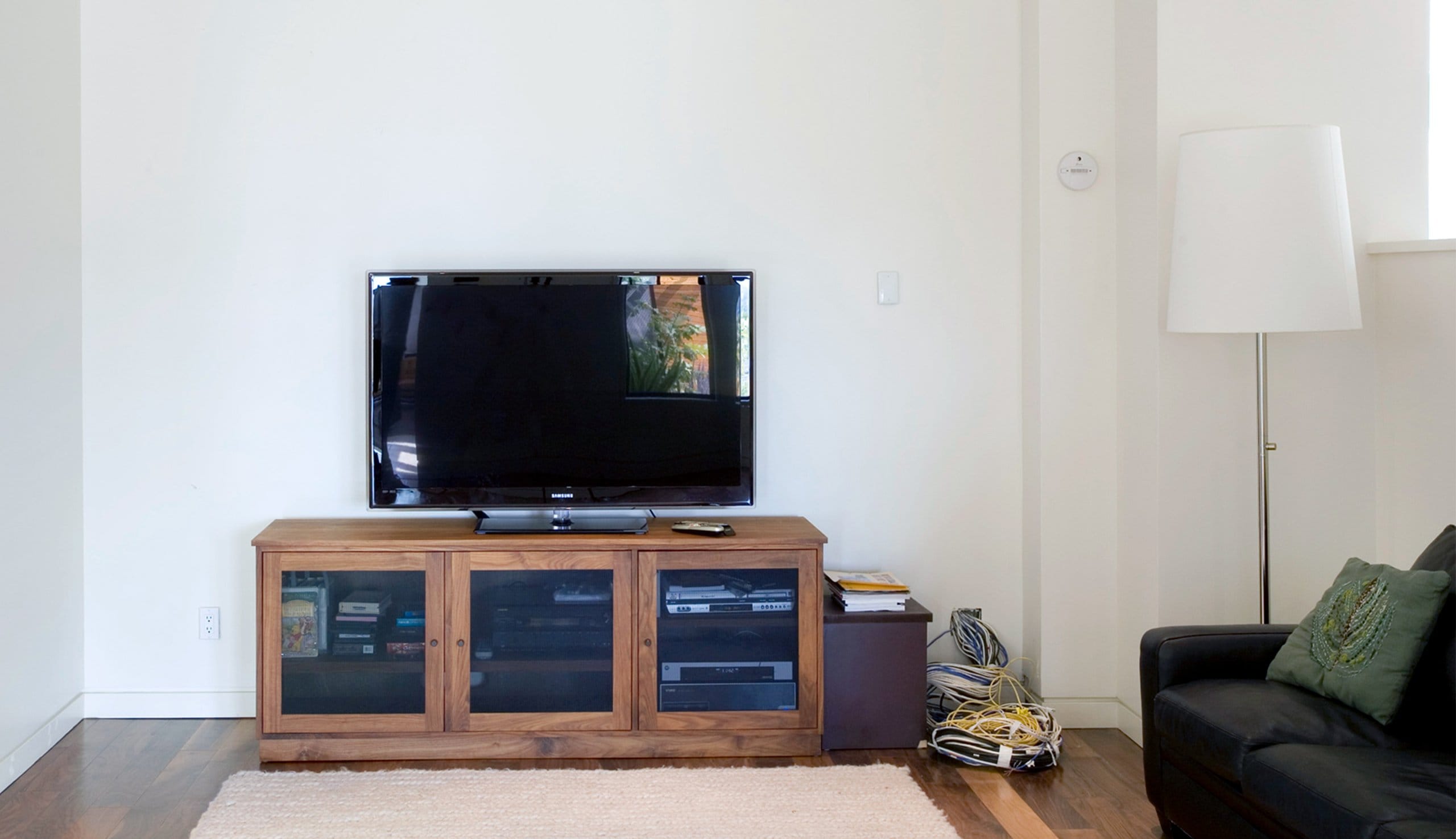 Family entertainment center with no storage space and not customized yet by California Closets